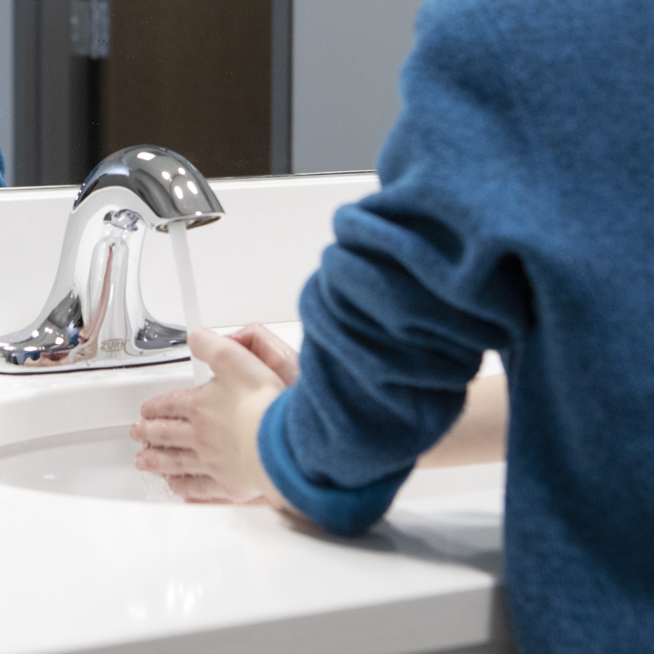 Detail of child washing hands